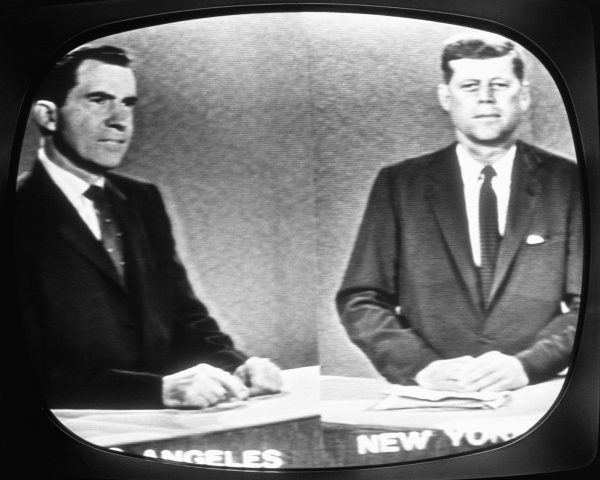 A black and white still of a television debate between Richard Nixon and JFK.