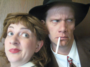 Close up on the faces of 1940’s detectives. The man looks silly with cigarette hanging out of his mouth, while the woman looks on disgusted.