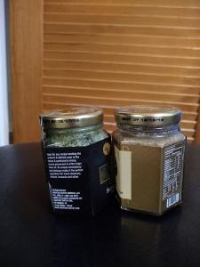 2 hexagonal jars on a table in front of a slated door.