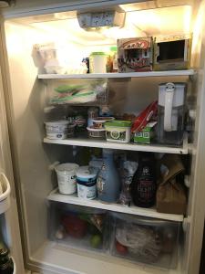 A very chaotic inside of a fridge. 