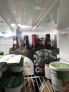 2 6-packs of bottled beer, not full, in the far back corner of a fridge. Hiding behind some yogurt. 