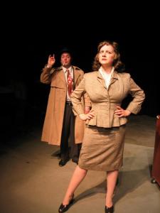 In the foreground, a 1940’s female detective is looking puzzled, while a male in the background is trying to get her attention.