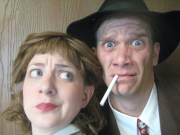 Close up on the faces of 1940’s detectives. The man looks silly with cigarette hanging out of his mouth, while the woman looks on disgusted.