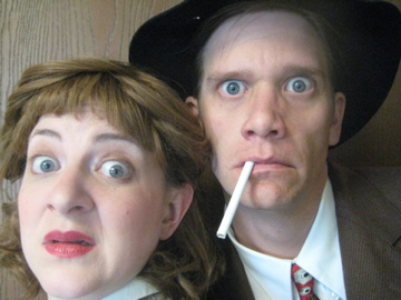 Close up of two 1940’s detectives looking scared.