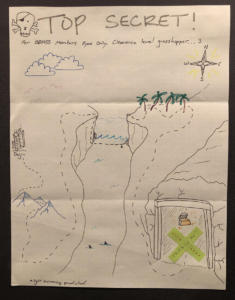 A drawing of a top secret treasure map. A green X marks the spot. The map starts at a city and travels through mountains, across a canyon filled with water and sharks, through palm trees to a cave with a treasure chest.