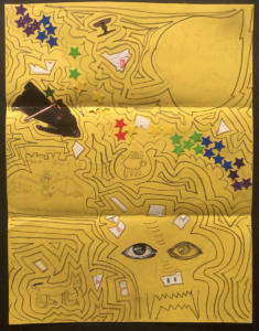 A pencil doodle on a bright yellow piece of paper. Lots of lines and various shapes surround a scary face, a fanged cat, and a leaf shape. Stuck on to the page are colorful star stickers and a sticker of a black-clad person holding a light saber.