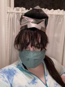 A selfie of a society member wearing an official BBPSS Members Only Hat made out of folded newspaper and a covid mask.
