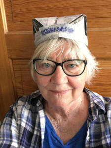 A selfie of a society member wearing an official BBPSS Members Only Hat made out of folded newspaper.