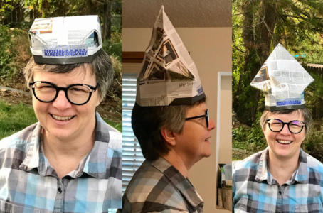 A society member displays their BBPSS Members Only Hat. Two hat styles are displayed. One hat style is square and flat and the other resembles a mitre.