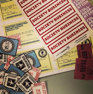 Lots of different BBPSS stickers are displayed: airmail, society business, collaboration. Under the stickers many Buntport Bored Post Society Society Membership Cards are displayed.