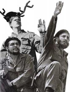 Cuban revolutionaries salute a crowd. A man, with antlers and a red deer nose, waves with them.