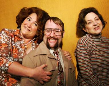 A 1970s family portrait, all in shades of brown and mustard. Everyone smiles are strained. The daughter is separated slightly from the parents.